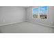 Bright bedroom with large windows that allow for a lot of natural light and neutral-colored walls and carpet at 5414 Catmint Dr, Lake Hamilton, FL 33851
