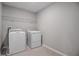 Laundry room equipped with new washer and dryer units and overhead storage rack at 5414 Catmint Dr, Lake Hamilton, FL 33851