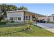 Neat manufactured home exterior, featuring a covered carport at 6022 Grand Oaks Se Dr, Winter Haven, FL 33884