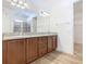 Bathroom with granite countertops, double sinks, and a walk-in shower at 663 Irvine Ranch Rd, Poinciana, FL 34759