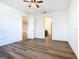 Well-lit bedroom with wood-look floors and ceiling fan at 663 Irvine Ranch Rd, Poinciana, FL 34759