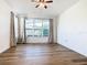 Bedroom with large window and wood-look flooring at 663 Irvine Ranch Rd, Poinciana, FL 34759
