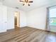 Bright bedroom featuring wood-look flooring and ceiling fan at 663 Irvine Ranch Rd, Poinciana, FL 34759