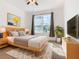 Bright bedroom with wood bed frame and large window at 663 Irvine Ranch Rd, Poinciana, FL 34759