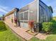 Home exterior with a screened patio and landscaped walkway at 663 Irvine Ranch Rd, Poinciana, FL 34759