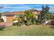 Single story house with tan exterior, landscaped yard, and brick driveway at 663 Irvine Ranch Rd, Poinciana, FL 34759