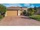 Two-car garage and attractive landscaping at 663 Irvine Ranch Rd, Poinciana, FL 34759