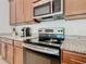 Sleek kitchen with stainless steel appliances and granite countertops at 663 Irvine Ranch Rd, Poinciana, FL 34759