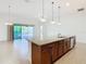 Island kitchen with granite countertops and stainless steel appliances at 663 Irvine Ranch Rd, Poinciana, FL 34759
