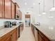 Bright kitchen boasts stainless steel appliances and granite countertops at 663 Irvine Ranch Rd, Poinciana, FL 34759