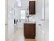 Bright laundry room, washer, dryer, cabinets, and granite countertop at 663 Irvine Ranch Rd, Poinciana, FL 34759