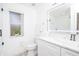 Clean bathroom featuring white cabinetry, illuminated mirror and glass shower at 733 Calabria Ave, Davenport, FL 33897