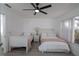 Light and airy bedroom with two beds, a ceiling fan and a view to a window at 733 Calabria Ave, Davenport, FL 33897