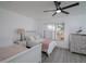 Bright bedroom featuring two twin beds, a ceiling fan, and natural light from the window at 733 Calabria Ave, Davenport, FL 33897