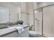 Clean bathroom features a glass-enclosed shower, a sink with modern fixtures, and a white toilet at 890 Pebble Beach Dr, Davenport, FL 33896