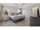 Comfortable bedroom features a king bed, soft lighting, and large windows offering natural light at 890 Pebble Beach Dr, Davenport, FL 33896