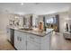 Spacious kitchen island with sink, double ovens, and breakfast bar at 890 Pebble Beach Dr, Davenport, FL 33896