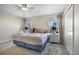 Comfortable main bedroom features a king bed, soft lighting, and large windows offering natural light at 890 Pebble Beach Dr, Davenport, FL 33896