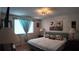 Bedroom with a large bed, an art piece above the bed, and window with drapes, complete with lamps at 1600 W Lake Parker Dr # B23, Lakeland, FL 33805