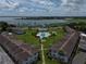 Aerial of condo community featuring a pool, lake view, and landscaped grounds for relaxing outdoor living at 1600 W Lake Parker Dr # B23, Lakeland, FL 33805