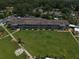 Aerial view of a well-maintained condominium complex with lush green lawns and mature trees at 1600 W Lake Parker Dr # B23, Lakeland, FL 33805