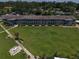 Aerial view of a well-maintained condominium complex with lush green lawns and mature trees at 1600 W Lake Parker Dr # B23, Lakeland, FL 33805