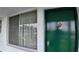 A classic green front door with a shiny knocker and adjacent window with privacy sheers at 1600 W Lake Parker Dr # B23, Lakeland, FL 33805
