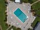 Aerial view of a sparkling blue swimming pool surrounded by lounge chairs and manicured landscaping at 1600 W Lake Parker Dr # B23, Lakeland, FL 33805