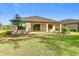 Back of the house shows a covered patio and grassy backyard at 195 Casavista Dr, Kissimmee, FL 34759