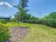 A spacious lawn features a young tree and well-maintained landscaping in the backyard at 195 Casavista Dr, Kissimmee, FL 34759