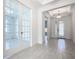 Bright foyer with glass doors, decorative ceiling, and wood-look tile flooring at 195 Casavista Dr, Kissimmee, FL 34759