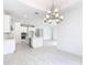 This open-concept kitchen features white cabinets and stainless steel appliances, creating a bright and modern space at 195 Casavista Dr, Kissimmee, FL 34759