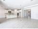 Bright kitchen flows into the home's open floor plan with white cabinets, stainless appliances, and a large center island at 195 Casavista Dr, Kissimmee, FL 34759