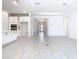 Open-concept living room with white walls, wood-look tile, and plenty of natural light at 195 Casavista Dr, Kissimmee, FL 34759