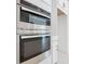 Close-up of stainless steel oven appliances, white cabinets and drawers at 195 Casavista Dr, Kissimmee, FL 34759