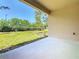 View from the covered patio to the grassy backyard and green space at 195 Casavista Dr, Kissimmee, FL 34759