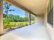 Wide covered patio looks out onto the lawn, bushes, and trees at 195 Casavista Dr, Kissimmee, FL 34759