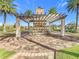 Community pergola with stone fireplace and landscaping at 195 Casavista Dr, Kissimmee, FL 34759