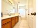 Bathroom featuring white tile floor, and wooden vanity with light countertop at 10786 Savannah Wood Dr # 126, Orlando, FL 32832