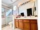 Bathroom featuring a glass enclosed shower and wooden vanity with white sink at 10786 Savannah Wood Dr # 126, Orlando, FL 32832