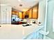 A well-lit kitchen with light countertops, wooden cabinetry, and stainless steel appliances at 10786 Savannah Wood Dr # 126, Orlando, FL 32832