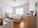 Bedroom with a large window, light purple walls, and light hardwood floors at 10786 Savannah Wood Dr # 126, Orlando, FL 32832