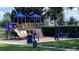 Community playground with slides, climbing structure, and seating area at 10786 Savannah Wood Dr # 126, Orlando, FL 32832