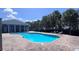 Sparkling pool surrounded by brick pavers and lush landscaping, perfect for relaxation and recreation at 10786 Savannah Wood Dr # 126, Orlando, FL 32832