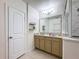 Bathroom with double vanity, granite countertop and a shower at 1940 Banner Ln, St Cloud, FL 34769