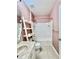 Cozy bathroom with pink walls, a shower-tub combination, and a stylish ladder shelf for storage at 1940 Banner Ln, St Cloud, FL 34769