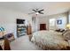 Bedroom with ceiling fan, built-in shelving and ensuite bathroom at 1940 Banner Ln, St Cloud, FL 34769