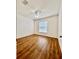 Bright bedroom with hardwood floors, a large window, and a ceiling fan providing comfort and natural light at 1940 Banner Ln, St Cloud, FL 34769