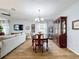 Bright dining room with hardwood floors, chandelier, and view into the living room at 1940 Banner Ln, Saint Cloud, FL 34769