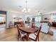 Open concept dining room with hardwood floors and view of the living area at 1940 Banner Ln, St Cloud, FL 34769